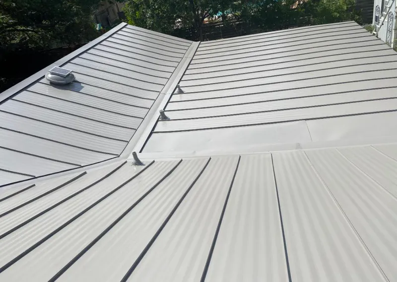 Solar attic fan installed on a metal roof for Roof Ventilation in Reisterstown